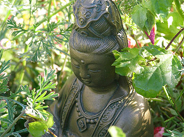 Quan Yin in a garden.